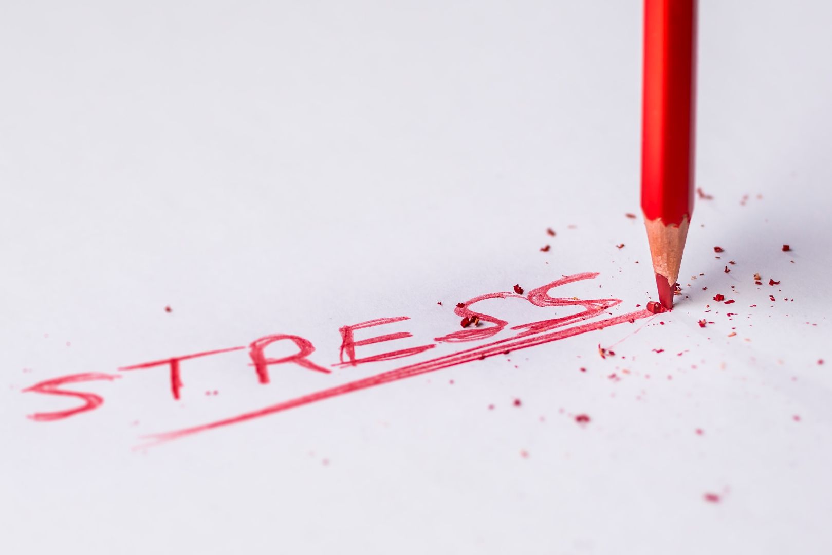 The word 'stress' written in red ink
