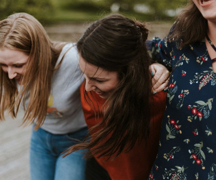 Young women with their arms around each other