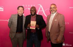 Ajibola Olajide-Shokunbi, winner of the Youth Work Award, with award presenter Carl Tring-Willis from Derby Homes and award host Amo Raju OBE DL