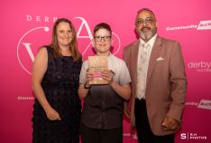 Corey Dobson, winner of the Young Volunteer Award, Age 5–17, with award presenter Amanda Ellse, Co-Director of Cosy Foundation, sponsors of this year's Young Volunteer Awards and award host Amo Raju OBE DL